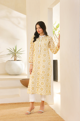 Off-white cotton chikan kari kurta with mustard embroidery, handcrafted tassels, and white slub viscose pants from Zananii’s Laaj Collection.