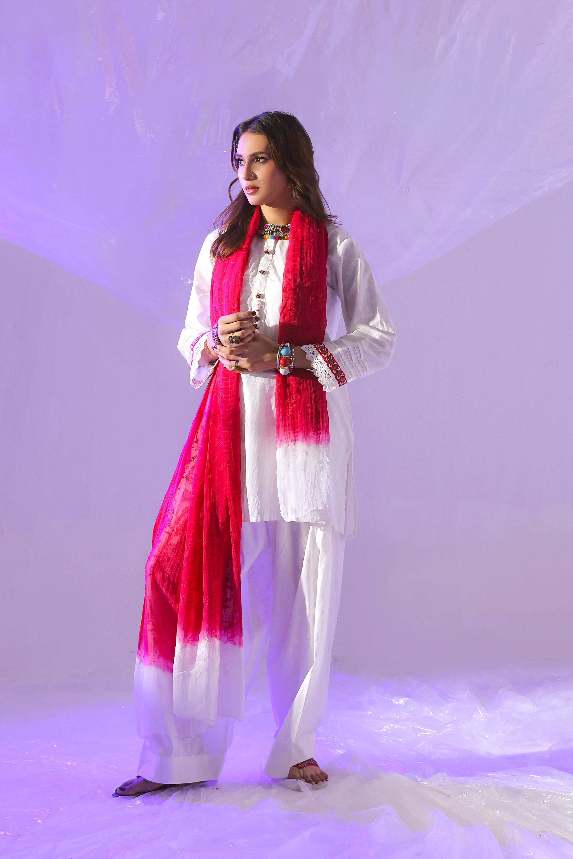 Ivory 3-piece self lawn suit by Zananii featuring embroidered buttons, lace-trimmed sleeves, a farshi shalwar, and a colorful tie-dye dupatta from the Gohar Collection.
