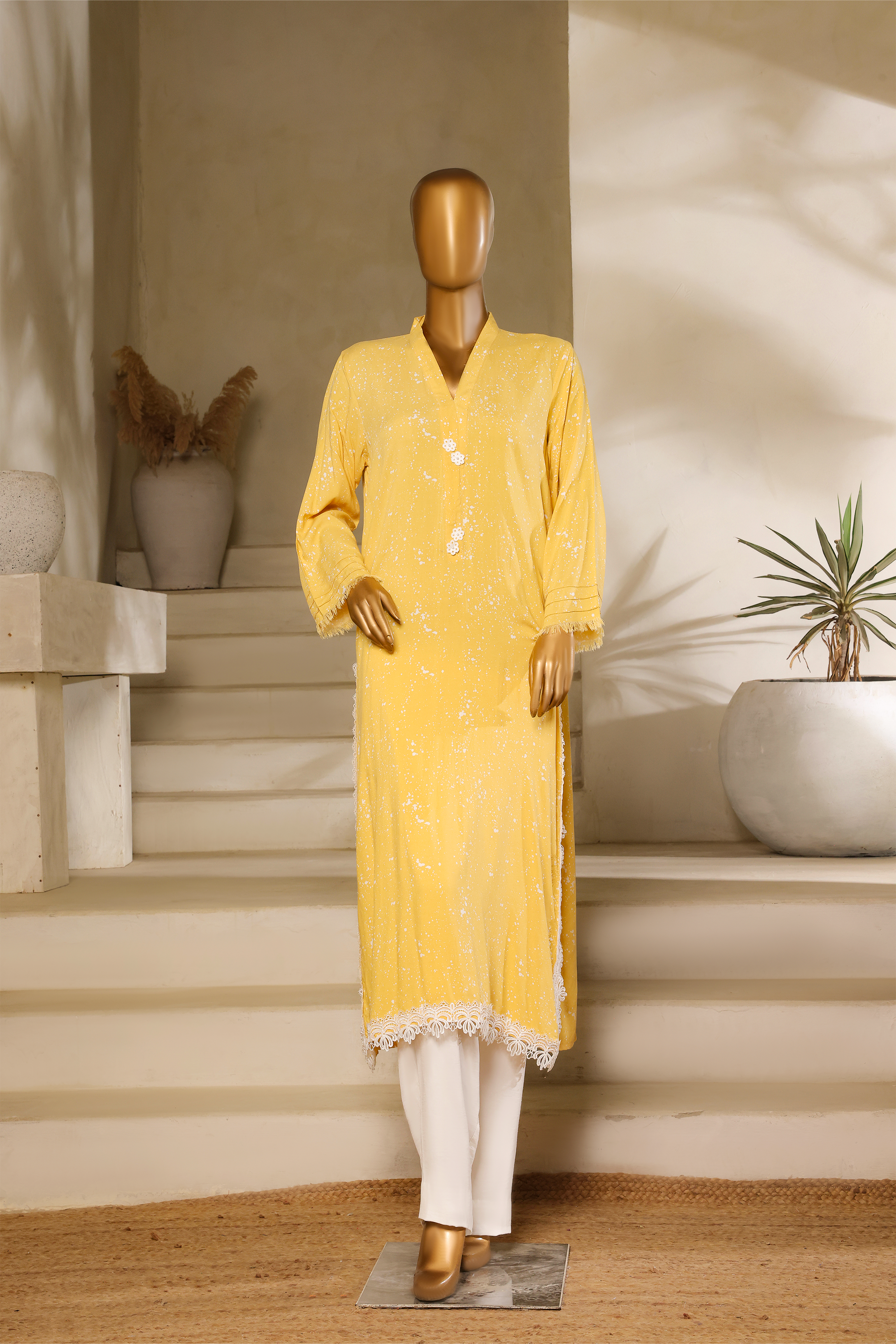 Yellow self-textured mul cotton kurta with white chicken lace detailing and button accents from the Ramz Collection by Zananii.
