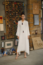 White viscose linen kaftan shirt by Zananii from the Saakht Collection, featuring tassel detailing on the collar and soft ruffle accents.