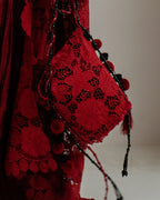 Maroon potli bag with resham tassels and pom-pom details, ideal for weddings and festive wear