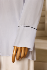 Third Light blue linen button-down shirt with silver buttons and mandarin collar from Zananii’s Zoya Collection.